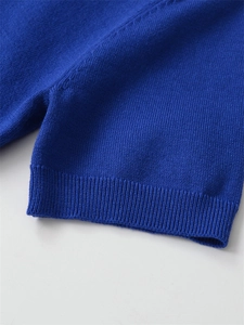 Detail of royal blue knit sweater showing ribbed cuff texture and fine stitching
