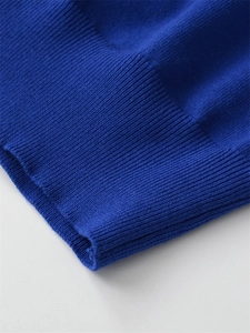 Close-up of royal blue knit sweater showing detailed ribbed texture on sleeve cuffs