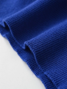 Close-up of the high-quality navy blue ribbed knit texture on a casual knitted sweater