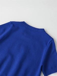 Macro detail of royal blue knit top showing fine ribbed neckline and soft texture