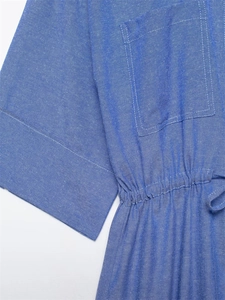 Detail of blue cotton-linen shirt featuring a square chest pocket and drawstring waist