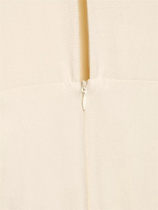 Detailed macro view of the seamless invisible zipper on this beige pleated midi dress