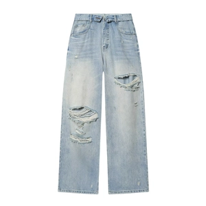 Street style light blue wide-leg jeans with distressed ripped detailing and cuffed hem