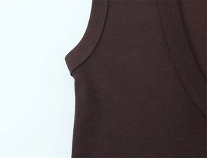 Detail of dark brown ribbed knit fabric showing double stitching and soft texture