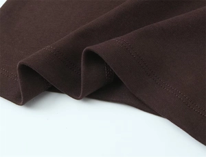 Macro shot of dark brown knitted fabric with double-needle stitching and ribbed texture