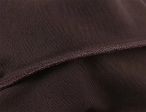 Macro shot of durable overlock stitching and knit fabric texture in chocolate brown