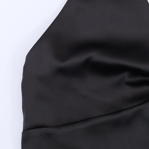 Close-up of black satin fabric showing smooth silk texture and elegant draping effect