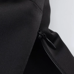 Macro view of seamless invisible zipper and textured satin fabric on a black top