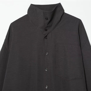 Minimalist charcoal grey high-collar oversized shirt with textured fabric and chest pocket