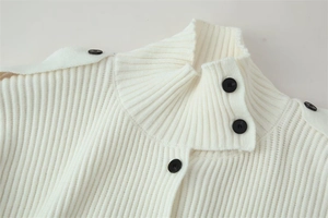 Detailed view of cream rib-knit high collar featuring contrasting black round buttons
