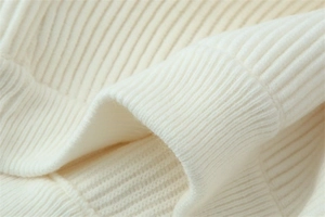 Close-up of premium ivory rib-knit cuffs showing detailed soft texture and quality fabric