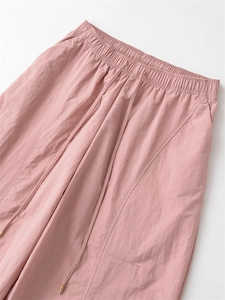 Vue détaillée de la taille élastique rose avec cordon de serrage et embouts dorés