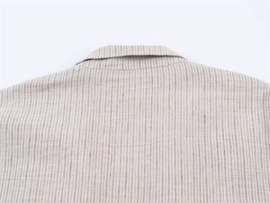 Primer plano del cuello del blazer gris a rayas que muestra la textura del tejido mixto