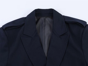 Detail of notch lapel and shoulder epaulettes on professional navy blue blazer