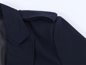 Detail of notch lapel and shoulder epaulets on a navy oversized blazer jacket