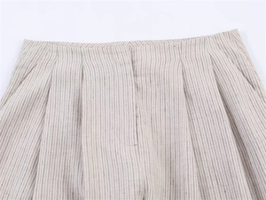 Primer plano detallado del pantalón de rayas de talle alto con pliegues y lino