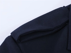 Detailed view of navy blue blazer epaulet showing fabric texture and neat stitching