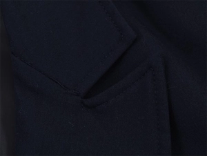 Detailed view of fine stitching and woven fabric texture on a navy oversized blazer