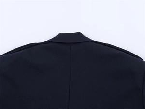 Detailed view of dark navy blazer jacket showing collar construction and shoulder epaulettes