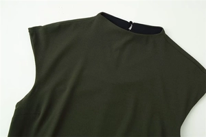Detail of dark green sleeveless dress showing back high neck button and teardrop cutout