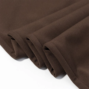 Close-up of premium brown knitted fabric texture and soft material on flare pants