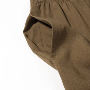Dettaglio ravvicinato della vita elastica marrone e della tasca laterale sui pantaloni