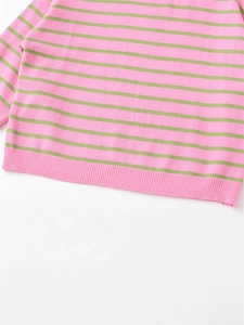 Close-up detail of pink and green striped knit sweater showing ribbed cuffs and texture