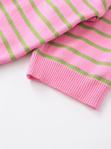 Detailed close-up of pink and green striped knit sweater cuffs with ribbed texture