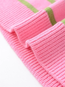 Macro view of pink and green striped ribbed knit cuffs on a casual sweater