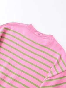 Close-up of ribbed neckline and vibrant pink and green striped knit texture details