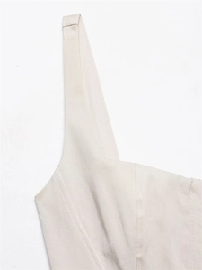 Detail of beige sleeveless dress showing premium woven fabric texture and stitching
