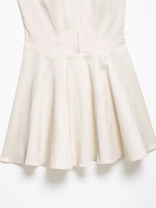 Close-up of high-quality ribbed fabric texture and stitching on a white waist dress