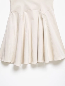 Detailed macro view of the textured ivory mini skirt hem with elegant A-line layering