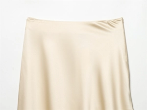 Detail of champagne gold silk satin skirt showing waistline and invisible side zipper