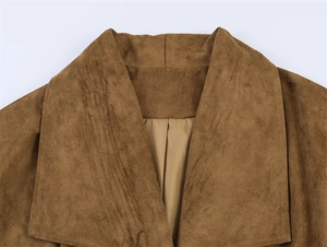 Close-up of wide lapel design and premium suede texture on brown wrap coat