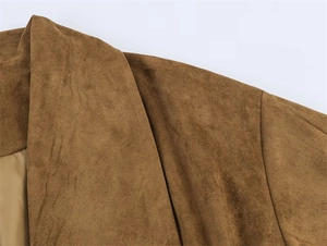 Macro detail of camel faux suede jacket showing shoulder stitching and smooth lining