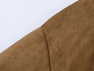 Close-up of brown suede fabric texture and stitching detail on the wrap jacket