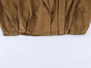 Detailed shot of brown suede fabric featuring fine pleats and soft velvet texture