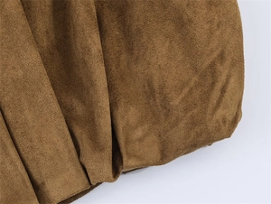 Detailed macro view of high-quality brown suede fabric with soft texture and drape