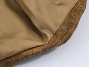 Detailed close-up of brown suede jacket inner lining with smooth golden satin fabric