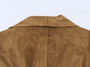 Detailed back view of brown suede coat showing precise stitching and soft velvet texture