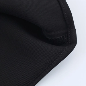 Close-up of black knitted twill fabric showing high-quality double stitching and texture