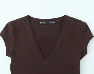 Detail shot of a deep V-neck short sleeve top showing the collar and brand label