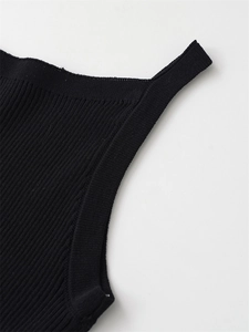 Close-up of ribbed knit texture and shoulder strap seam on a black sleeveless top