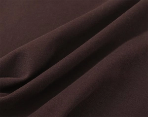 Macro shot of dark brown knit fabric showing soft texture and premium material weave