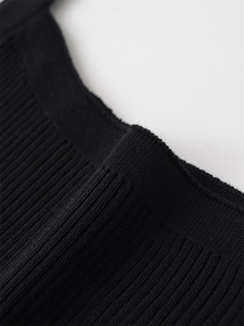 Detailed view of the high-quality stitching and ribbed texture on this black knit tank top