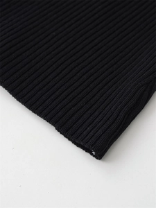 Close-up of premium black ribbed knit fabric showing stretch texture and fine stitching