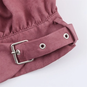 Close-up of dusty pink suede jacket waist belt with silver metal buckle and eyelets