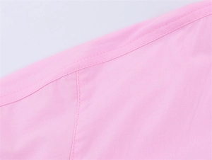 Detailed view of double-stitched seams on the pink poplin shirt's sleeve cuff