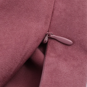 Close-up of seamless invisible zipper on premium smoky pink suede texture fabric